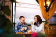 © yolya_ilyasova - Pregnant woman and her husband sitting at cozy cafe terrace in the fall