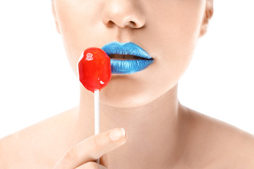 Sticker - Beautiful young woman with creative makeup and lollipop on white background, closeup