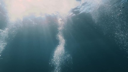 Wall Mural - air bubbles rising underwater in sea water