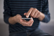 © pcruciatti - Young man using a touchscreen smartphone - Hands close-up - Using technology