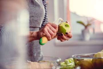 Wall Mural - Woman peeling apples