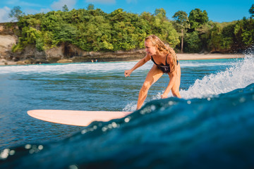 Wall Mural - Surf girl on surfboard. Woman during surfing. Surfer and  wave