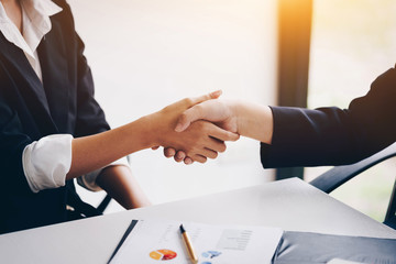 Businesswoman shaking hand for a complete business deal together successful, finishing up a meeting. Teamwork concept. Partnership concept and dealership concept.