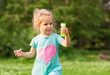 © Lucky Fenix - female child in park with soap bubbles.