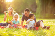 © Lucky Fenix - Happy family in the park together on a sunny day - children blow soap bubbles outdoor.