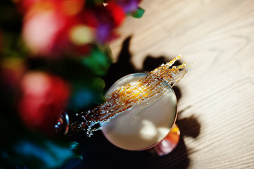 Alcoholic cocktail with fused sugar in bronze glass on bar table.