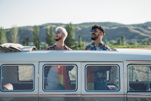 Gay Couple In Van Holding LGBT Flag