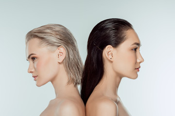 beautiful naked multicultural girls posing back to back, isolated on grey, natural beauty