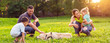 © Lucky Fenix - happy family is having fun with golden retriever - family playing with dog in park.