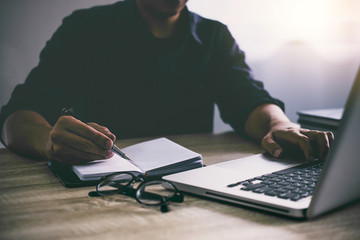 Poster - Professional at work, businessman writing report and using laptop working analysis investment connection at modern workplace