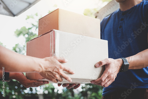 Fotografía Home delivery service and working service mind, Woman customer hand receiving a