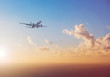airplane flying above  ocean with sunset sky background   - travel concept  
