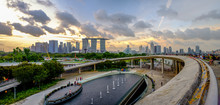 Panoramic View Singapore's Marina Barrage Overlooks Marina Bay Sands And Gardens By The Bay At Twilight Time.