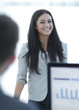 © ASDF - successful business woman standing near a work table