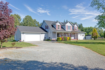 Wall Mural - Cute home exterior with red shutters on a summer day.