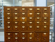 Oak wooden library catalog drawer sitting in a modern library 