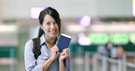 Canvas Print - Cheerful woman holding passport at airport