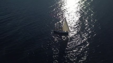 Poster - lonely isolated yacht under the sail with tall mast going in still sea aerial top view