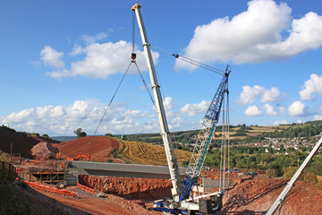 Wall Mural - Crane lifting a bridge beam