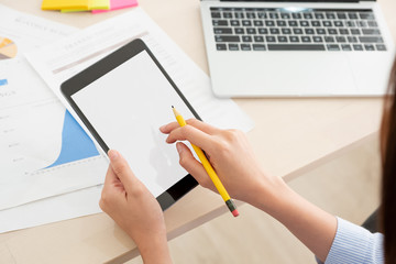 Poster - Shoulder view of woman use tablet and  laptop working online on table at home.mock up template device screen.Digital lifestyle concept.clipping path screen.