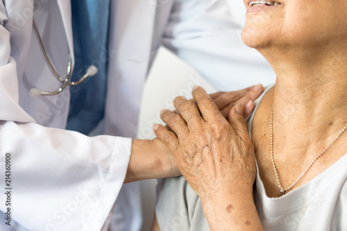 Elderly Female Hand Holding Hand Of Young Caregiver At Nursing