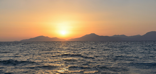 Wall Mural - the panoramic photo of a decline on the seashore, against the background of mountains