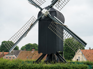 Post mill type windmill in Dutch landscape