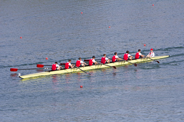 Rowers in eight-oar rowing boats on the tranquil lake