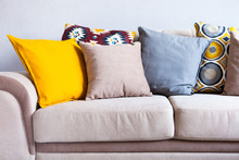Multi-colored Pillows On A Beige Fabric Sofa, The Concept Of Home Comfort And Cozy, Copy Space, Close Up