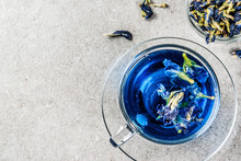 Healthy Drinks, Organic Blue Butterfly Pea Flower Tea With Limes And Lemons, Grey Concrete Background Copy Space Above
