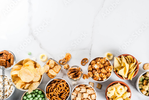 Cuadros en Lienzo Variation different unhealthy snacks crackers, sweet salted popcorn, tortillas,