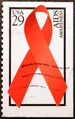 AIDS red ribbon on american postage stamp