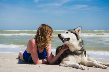 Female in glasses and swimwear with pet