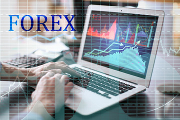 Poster - Double exposure of graphs and financial trader working with laptop at table in office. Forex concept