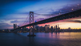 Fototapeta Most - Aerial Cityscape view of San Francisco and the Bay Bridge with Colorful Sunset