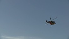 A Single Helicopter Circles In The Sky Preparing For Landing