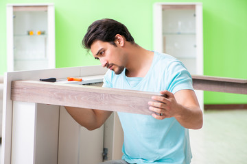 Man repairing furniture at home