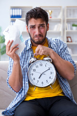 Man frustrated at bills he needs to pay in time management conce