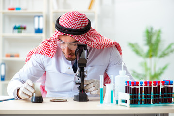 Wall Mural - Arab chemist scientist testing quality of oil petrol