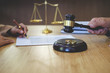 © MIND AND I - Judge gavel with Justice lawyers  deciding, consultation on marriage divorce between married couple and signing divorce documents on table. Concepts of Law and Legal sevice