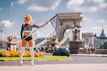Sexy Grid Girl Hostess Woman Holding Starting Car Racing Flag  In Budapest