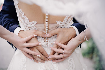 wedding photo of wedding rings on the hands of a couple. heart