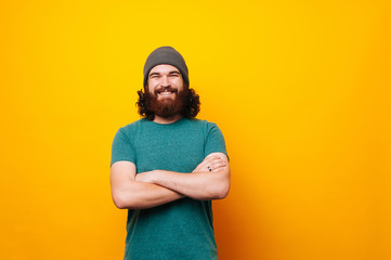 Cheerful smiling bearded hipster man looking confident at the camera