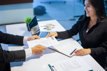 Businessmen and Businesswomen discussing documents for job interview concept