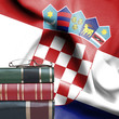Education concept - Stack of books and reading glasses against National flag of Croatia