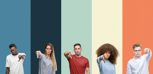 Wall Mural - Group of people over vintage colors background looking unhappy and angry showing rejection and negative with thumbs down gesture. Bad expression.