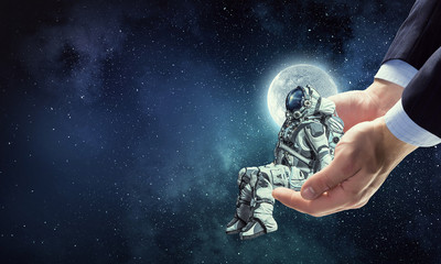 Wall Mural - spaceman on finger. mixed media