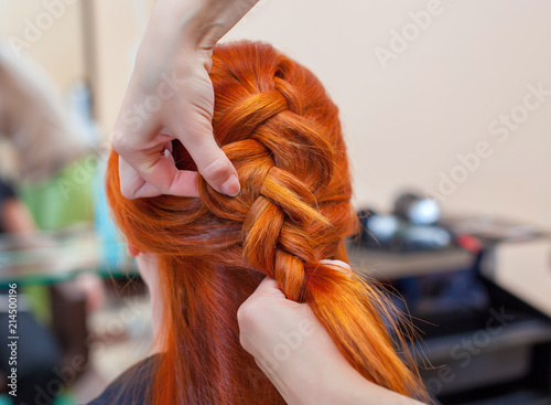 Beautiful Girl With Red Hair Hairdresser Weaves A Braid Close Up
