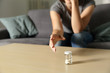 Woman hand reaching a bottle of painkiller capsules