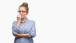 © Krakenimages.com - Young blonde business woman looking stressed and nervous with hands on mouth biting nails. Anxiety problem.